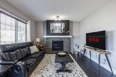The living room features a smart TV with access to popular streaming apps. Guests can enjoy movies and shows with their own subscriptions.