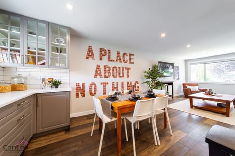 Enjoy meals in a bright, modern kitchen with sleek cabinetry and a stylish dining area that comfortably seats six. Ideal for family gatherings and entertaining.