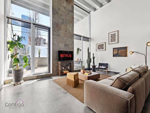Your Urban Oasis: Chic Sofa, Smart TV (use your own subscription), and Endless Entertainment.