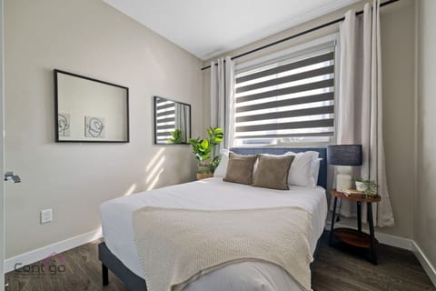 Relax and unwind in our comfortable queen bedroom featuring blackout curtains.