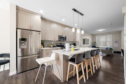 Meal prep is a breeze here! Full-sized refrigerator to store your groceries and beverages, and cook your favorite dishes on the four-burner stove. The kitchen island is perfect for dining, and a high chair for your little one.