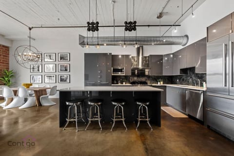 Large modern kitchen with upscale stainless steel appliances great for dining in.