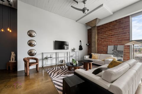 Chic living room with comfortable seating and vibrant city views.