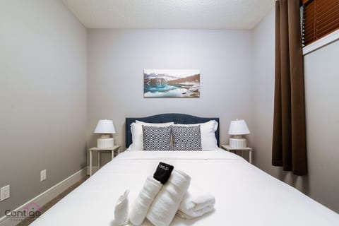 Cozy bedroom with a plush queen bed, fresh linens, and soft lighting—perfect for a restful night after exploring the city.