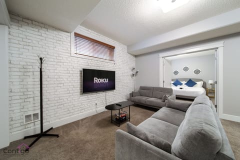 Relax in the family-friendly living room featuring a plush sofa and smart TV (own subscription required) for your entertainment needs. Bright, inviting space ideal for unwinding after exploring the city.