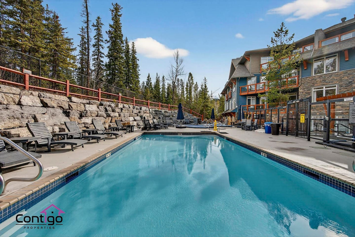 Outdoor heated pool with mountain views at 170 Kananaskis Way, Canmore — a top-rated Alberta Rockies vacation rental with premium resort amenities.