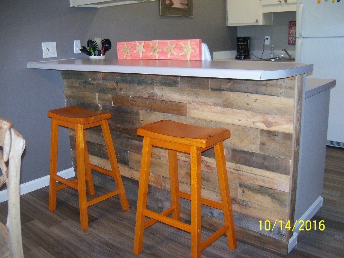Bar area, LED lighting, beach trim, new stools.