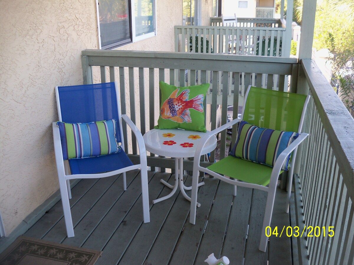 Our outside deck area with chairs and a storage bin for beach gear.