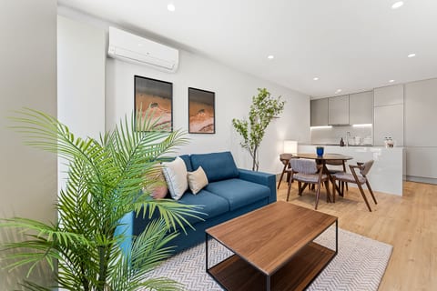 Bright modern living space with sleek kitchen and cozy dining area