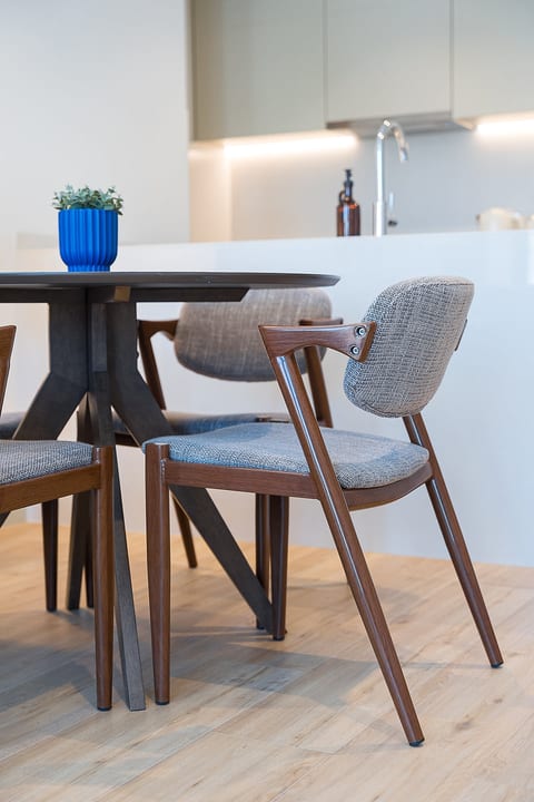 Stylish dining nook with designer seating and sleek modern kitchen