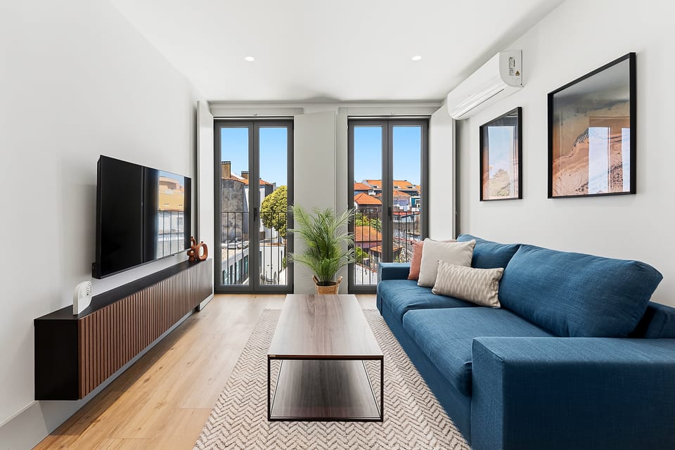 Bright modern lounge with balcony views and cozy blue sofa