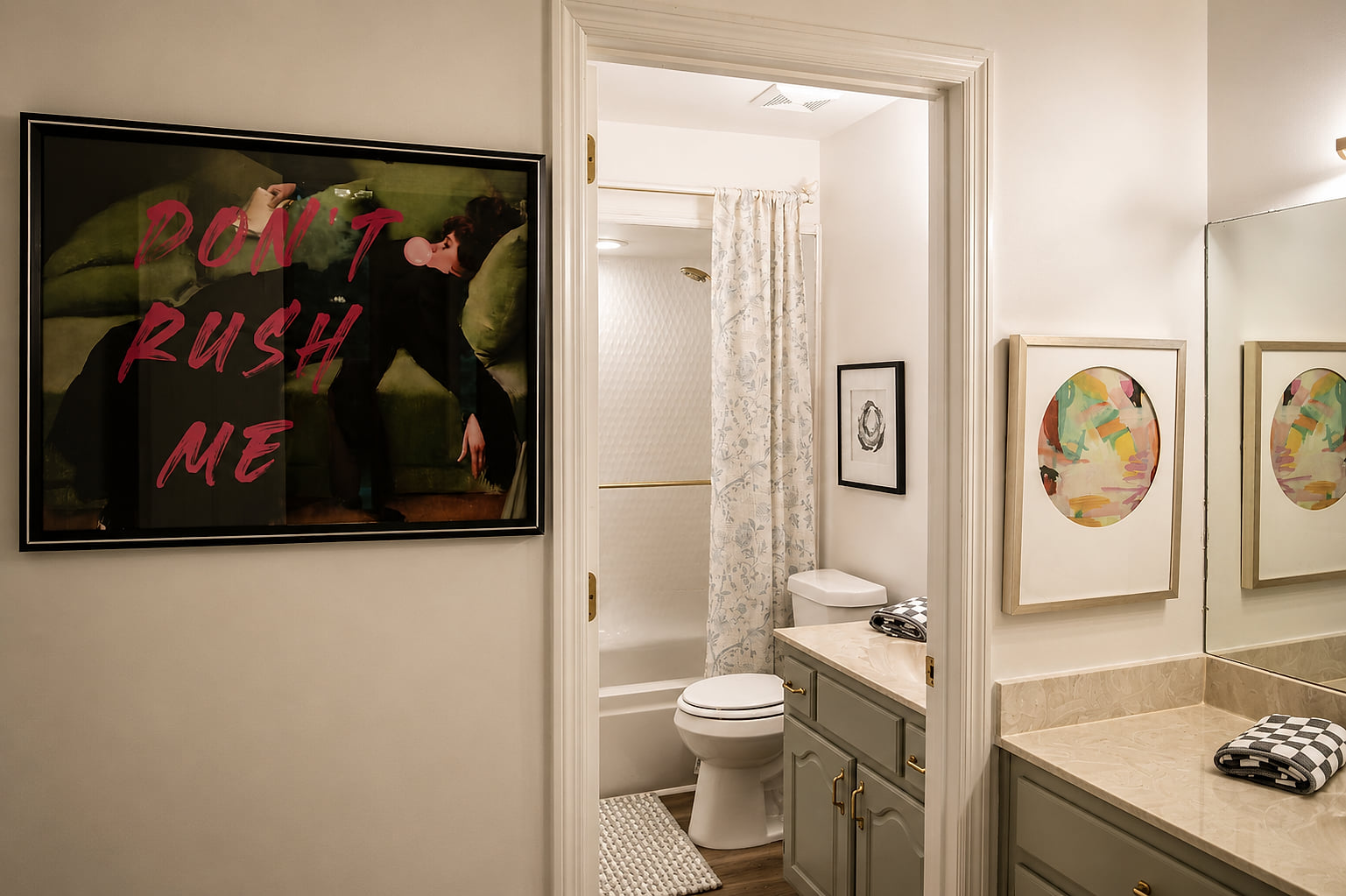 Stylish dual bathroom setup with elegant vanity and bold art accents