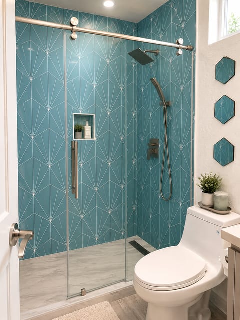 Spa-like bathroom with bold blue tile and sleek glass walk-in shower