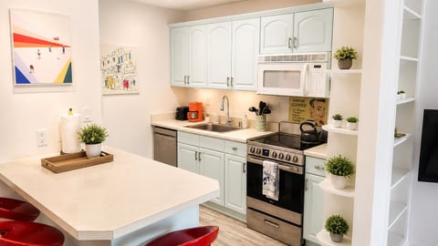 Bright kitchen with breakfast bar, coffee station, and stylish modern touches