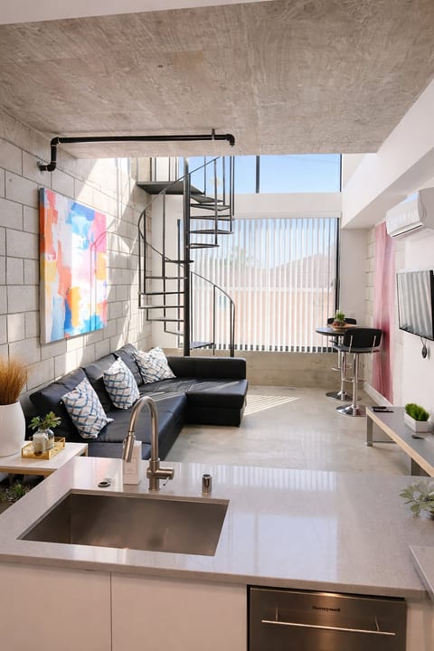 Sunny loft with spiral stairs, sleek kitchen, and soaring windows