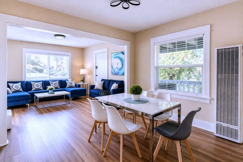 Bright open living-dining, modern décor, seating for six, cozy vibe.