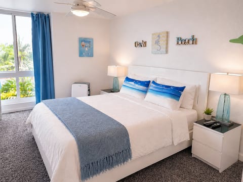 Bright coastal bedroom with tropical views and serene beach-inspired decor