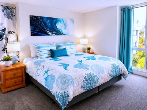 Sunny coastal king suite with large window and serene ocean vibes