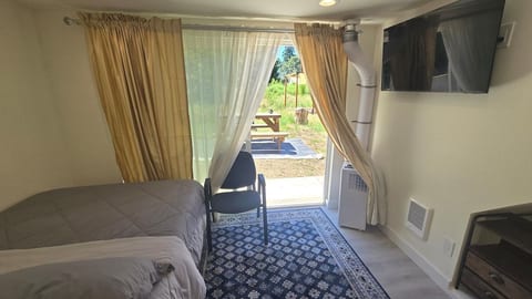 This bedroom has a sliding door and its own access to the backyard. The sliding glass door offers a nice view of the backyard.