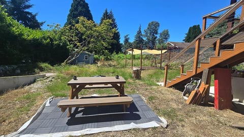Our backyard offers a picnic table, a patio deck and some exercise machines on that shared upper deck.