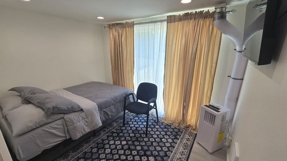Bedroom #4 which sleeps 2 people with TV, AC/heater and private bathroom.