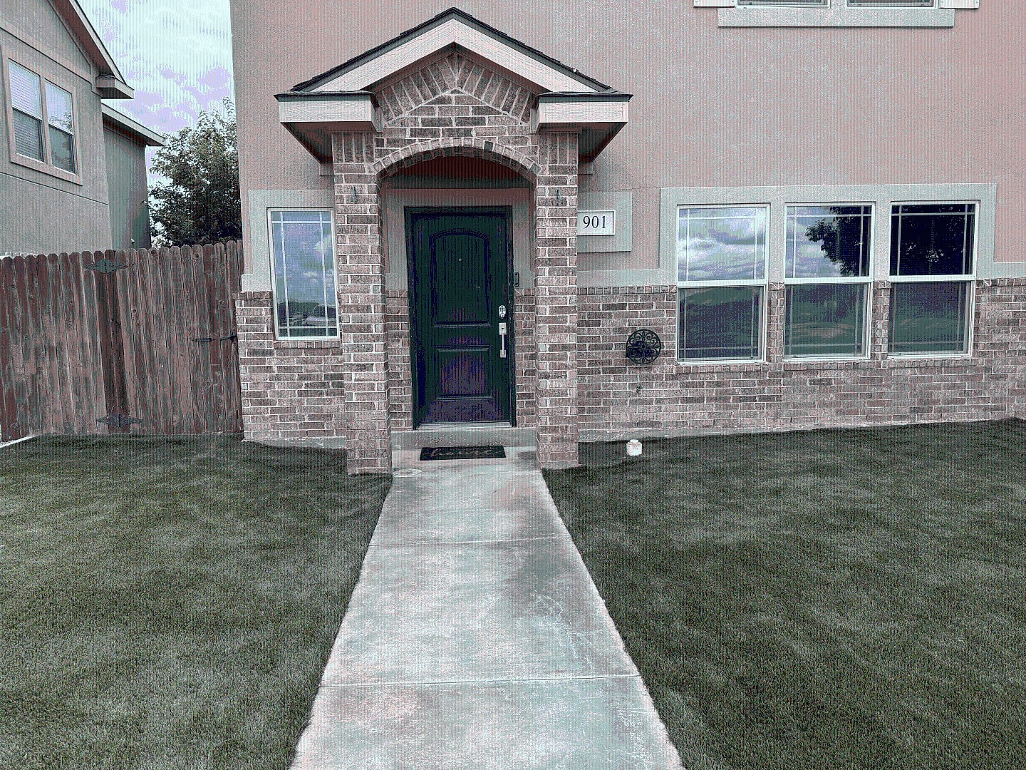 Step up to Sunset Retreat — a freshly landscaped front yard with new turf and a tidy walkway leading right to your door.