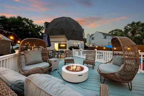 Fire pit and outdoor seating on a huge blue deck.