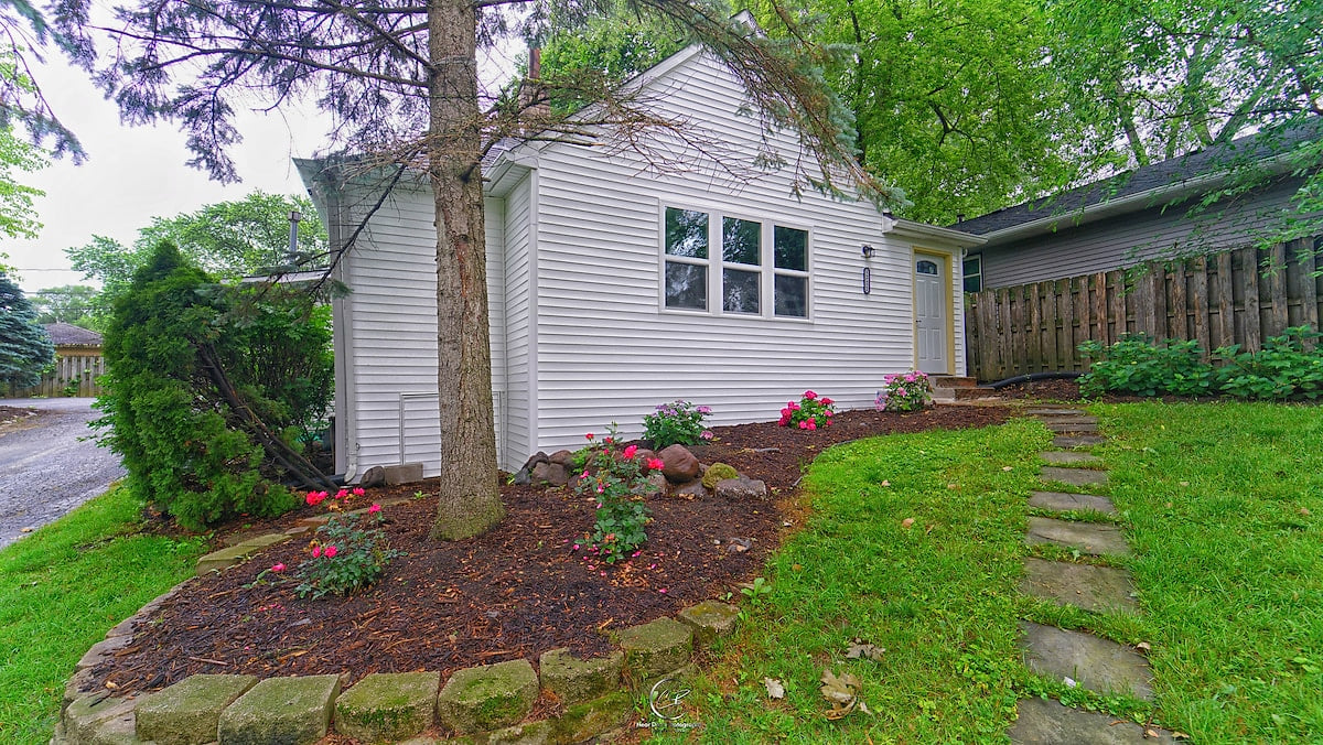 The front of the house, nicely maintained flowers and path.