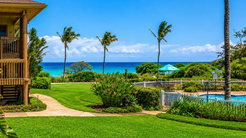 Steps from your door green lawns, the pool, and the blue Pacific.