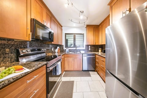 Full-size fridge, dishwasher, and granite — cook in like a local.