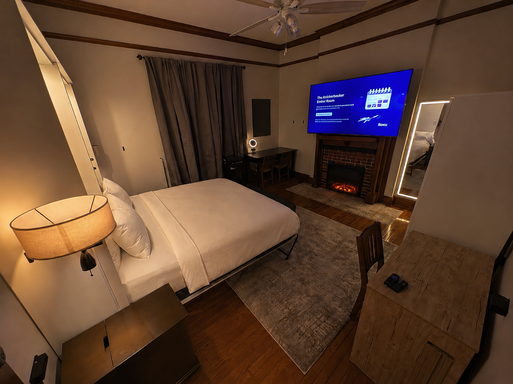 Ember Room looking in at 75" TV, frontlit mirror, fireplace.