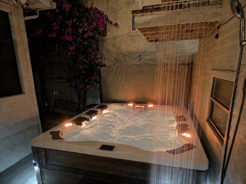 9 seat Hot tub at night, overhead lights off, shower running.