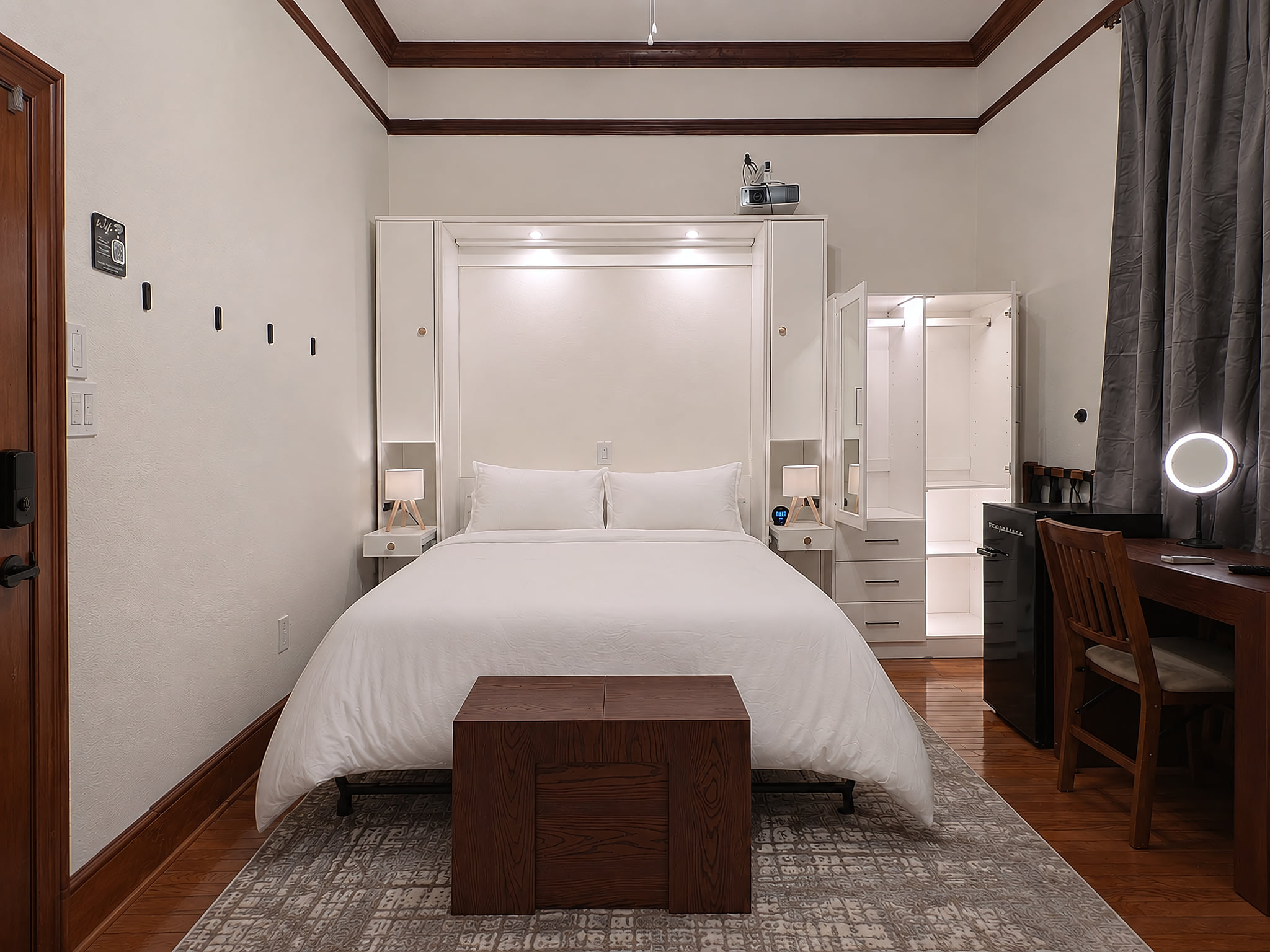 Watersong Room Queen bed with lights on, armoire, 4k projector, desk.