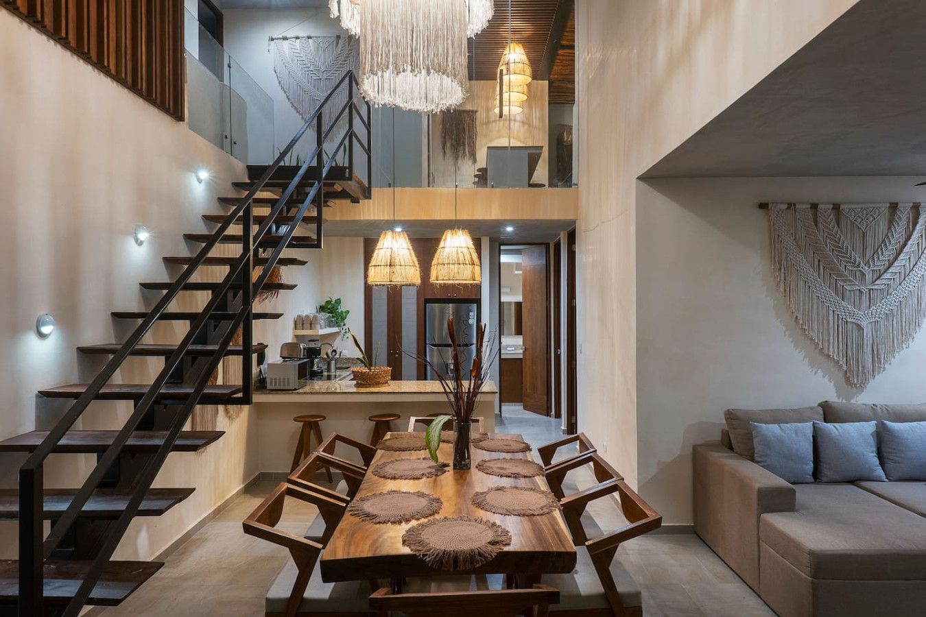 The living room has been thoughtfully decorated with beautiful local touches, including the large macramé piece on the wall and the charming hanging lamps.