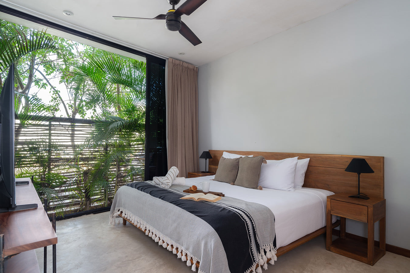 This tranquil bedroom offers a plush king bed, soothing daylight, and beautiful garden views—perfect for rest and renewal.