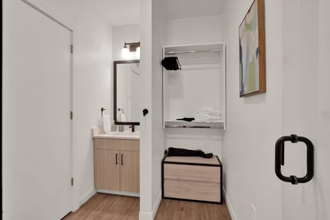 Bright modern entry nook with vanity and convenient closet storage