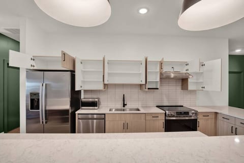 Bright modern kitchen with island, stainless appliances, and ample storage