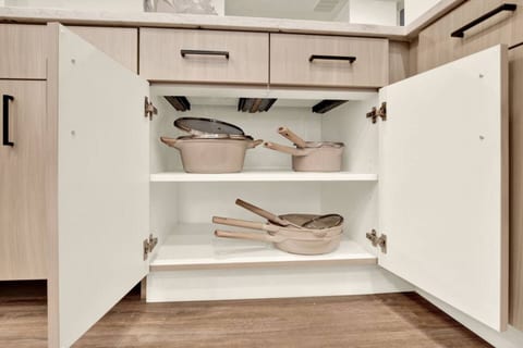 Well-stocked modern kitchen with neatly organized cookware storage