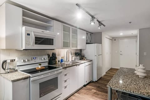 Bright modern kitchen with granite counters and full-size appliances