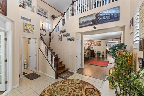 Grand entryway with soaring ceilings, elegant staircase, and open layout