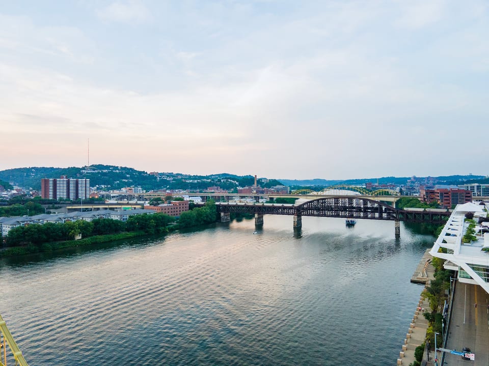 Scenic riverfront views with bridges and a glowing city skyline