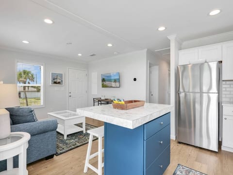 Designed for comfort and connection, this inviting space blends the kitchen and living areas into one bright and welcoming retreat.