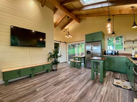 Living room with vaulted, open beam, ceilings and tons of natural light. Custom cabinetry and furnishings give this little cottage a truly craftsman feel.