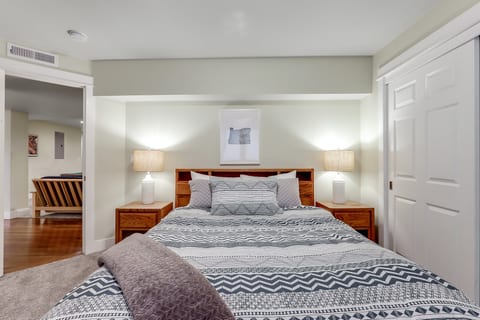 Cozy, well-lit bedroom with plush bedding and spacious closet