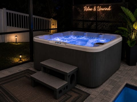 Private hot tub with relaxing jets, LED lighting, and a peaceful setting for unwinding day or night.