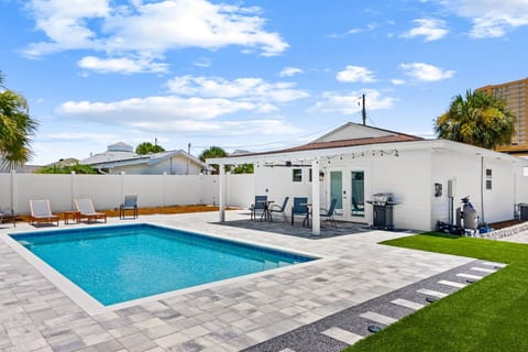 Your private resort-style backyard includes a sparkling pool, covered patio, and BBQ grill for outdoor dining.