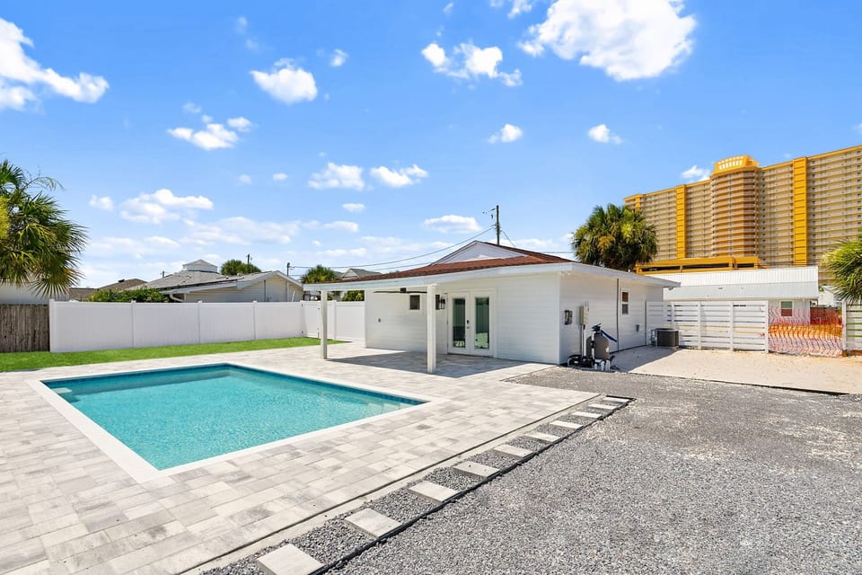 Enjoy your own private backyard oasis with a sparkling pool just minutes from the beach.
