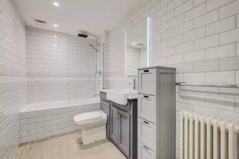 Beautiful Bathroom fully tiled in London "Metro" Tile with 24 Hour Hot Water and : Shower/bath/Wash hand basin with Vanity Unit/ WC/storage/towel rail/Extractor fan/LED mirror/Radiator