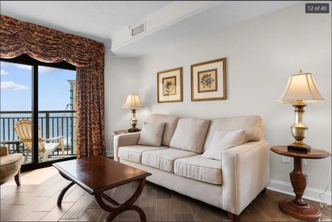 Stylish and welcoming sitting area with plush sofas, warm lighting, and tasteful décor—ideal for movie nights or quiet reading time.