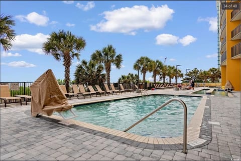Enjoy ocean breezes and palm-lined views while lounging beside the outdoor pool—your perfect spot for soaking up the Myrtle Beach sunshine.
